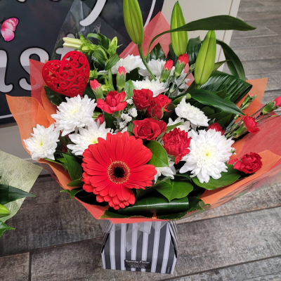 Mrs Kisses - Send lots of love and kisses with this classic hand-tied bouquet featuring a selection of romantic flowers finished with a luxurious single red rose.