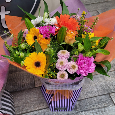 Splash of Colour - A vibrant gerbera posy hand-tied featuring a mix of colours carefully selected by the local florist. Hand-delivered in a gift bag or box.